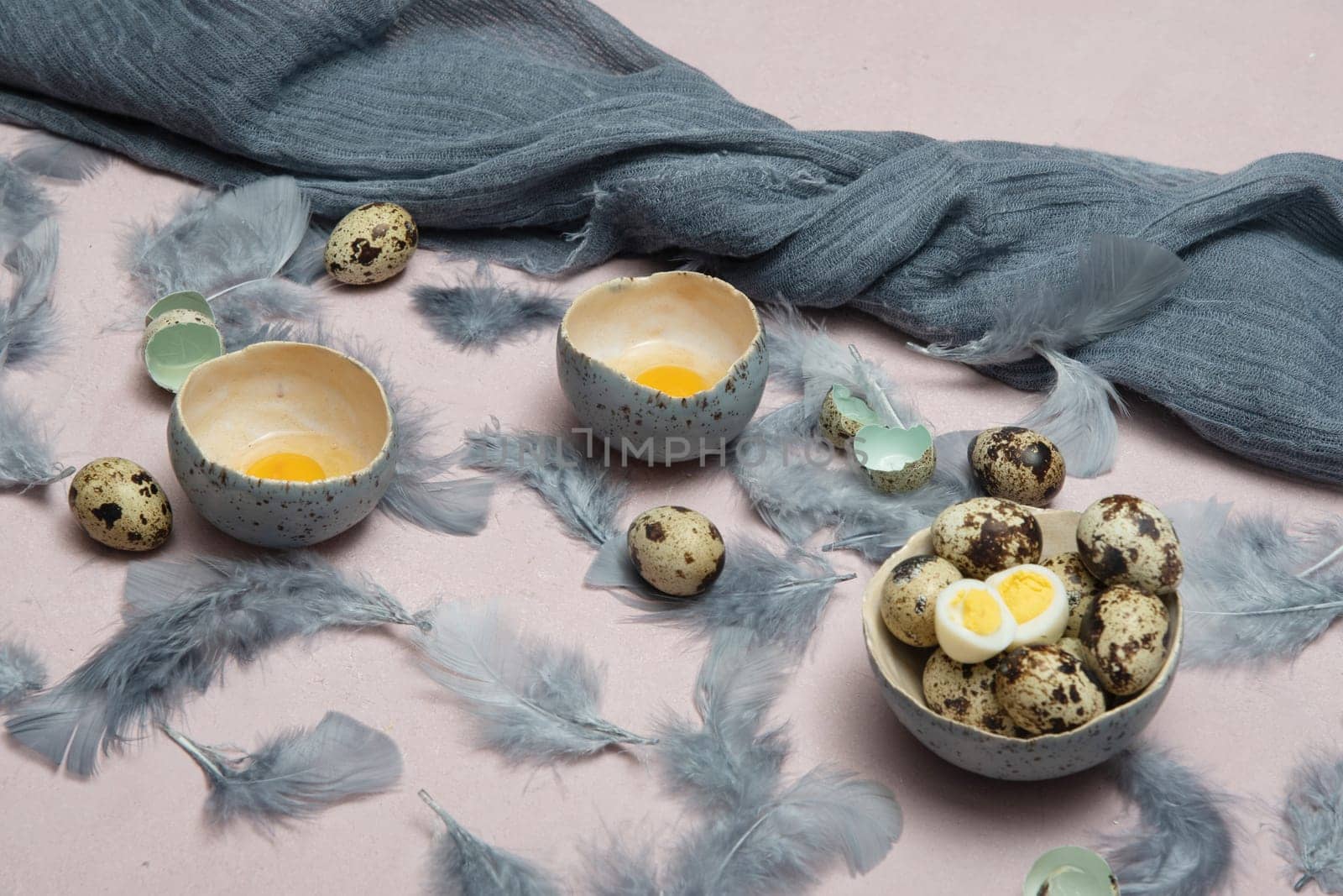 quail eggs in ceramic vases, gray feathers on the table, Easter still life with dietary eggs, diet and antioxidants, dark key and shallow depth of field, high quality photo