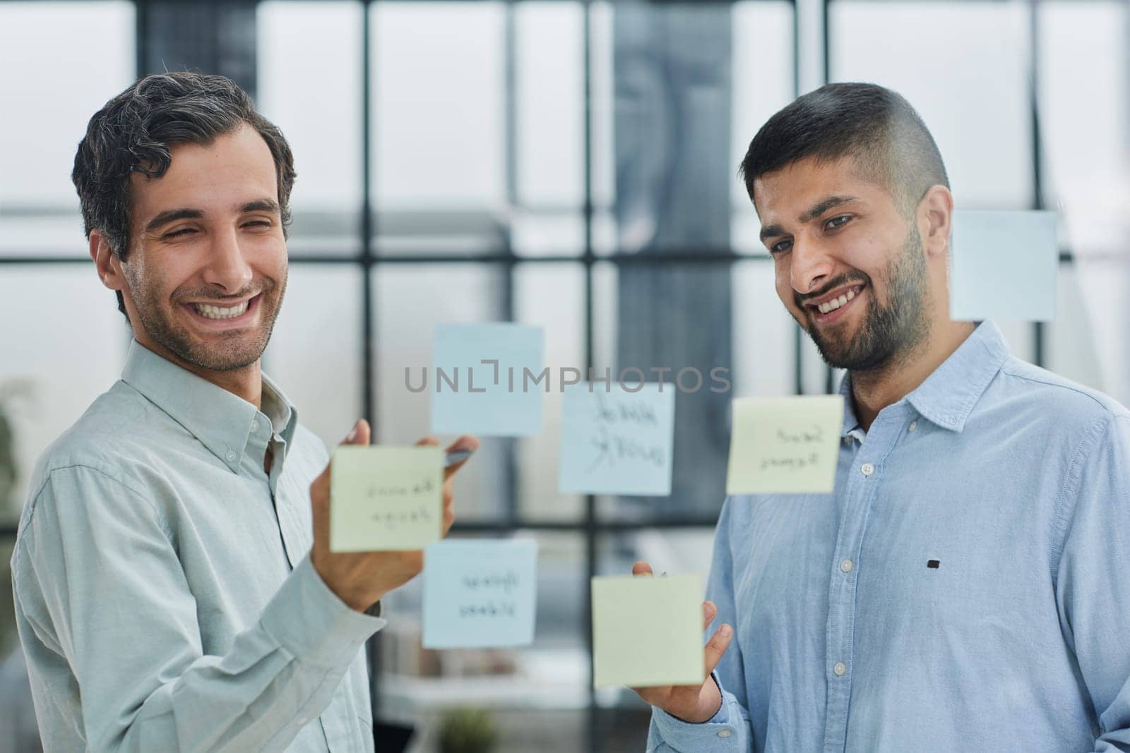 two successful businessmen in the office discuss a plan in office