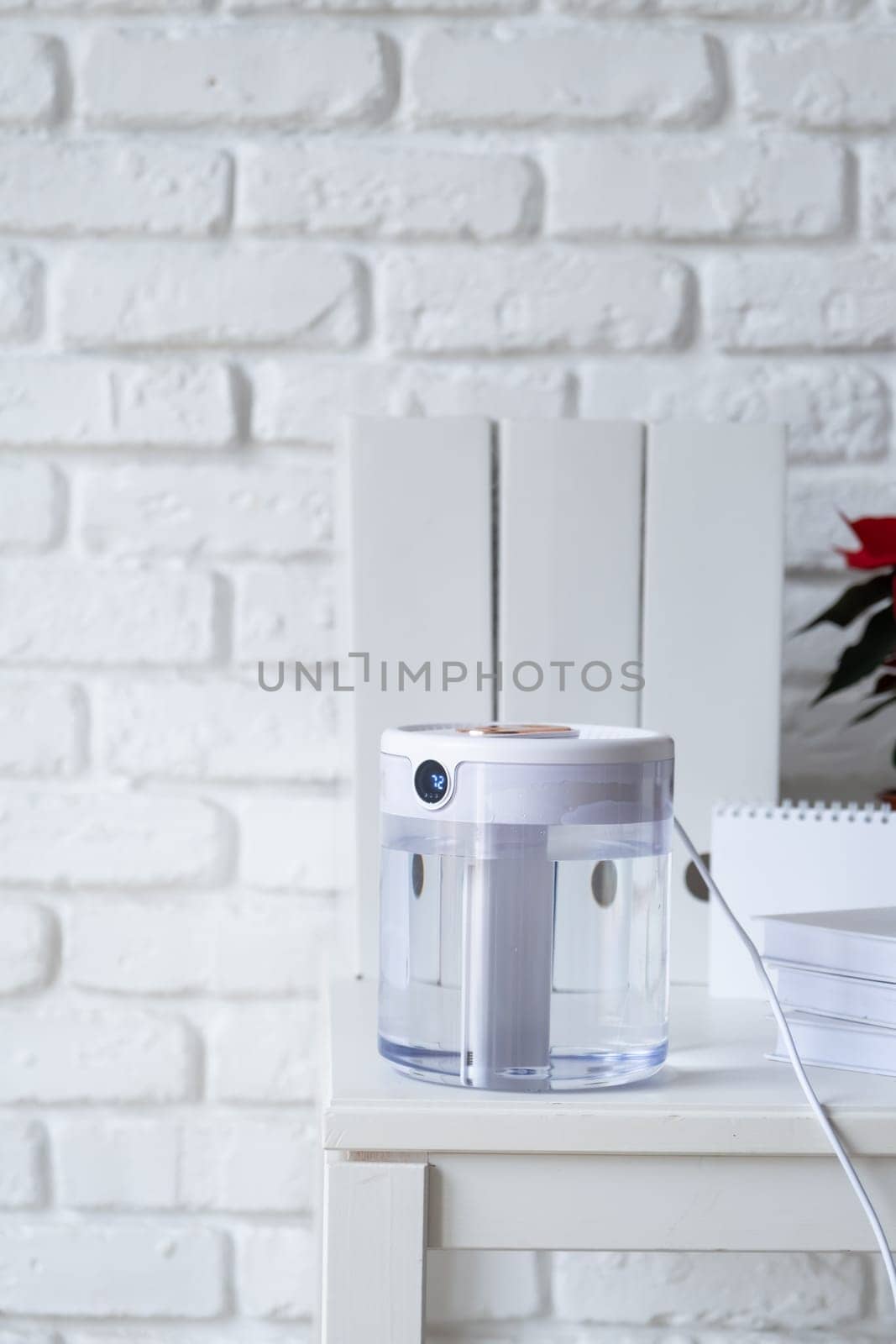 Modern air humidifier on table in living room or office . Space for text by Desperada