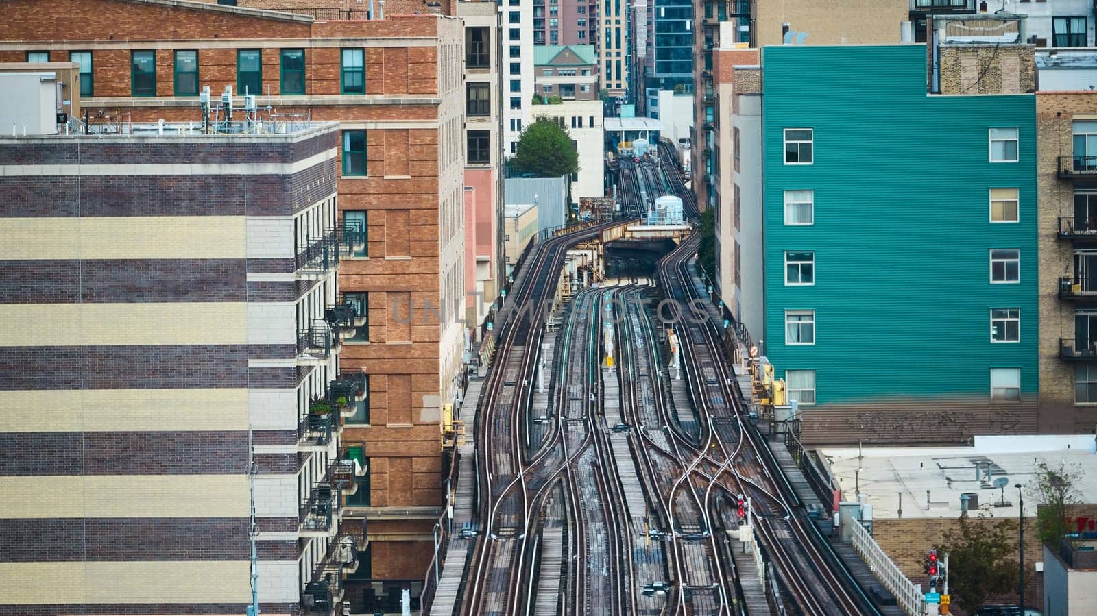 Image of Empty train tracks in city, travel, transportation with aerial of buildings lining railroad, Chicago