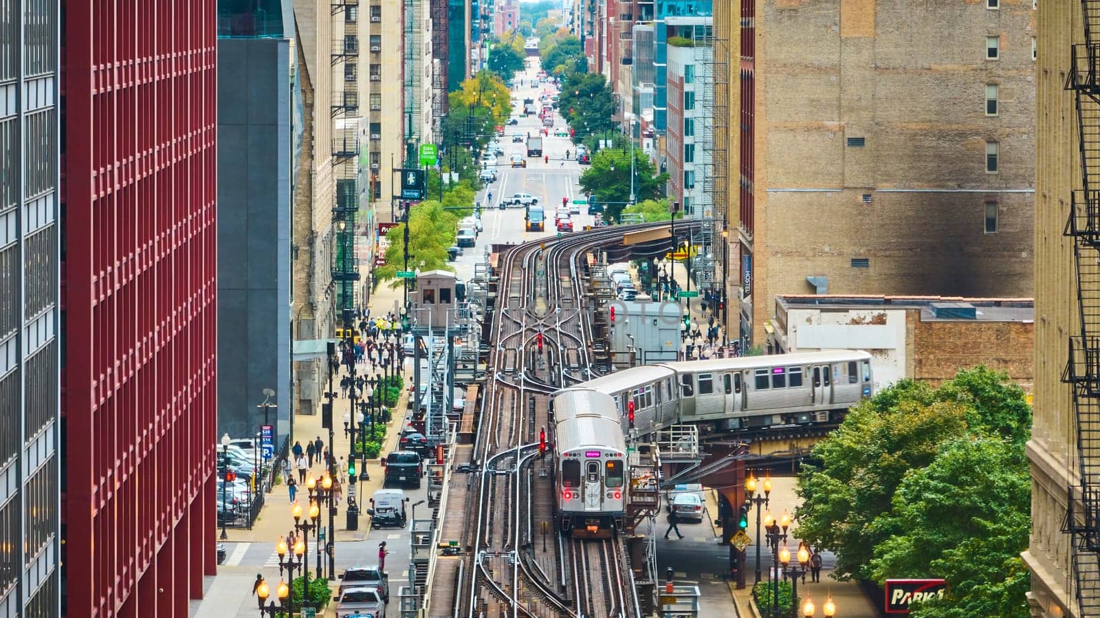 Image of Train on tracks in Chicago aerial of big, inner city transit, travel and tourism with buildings