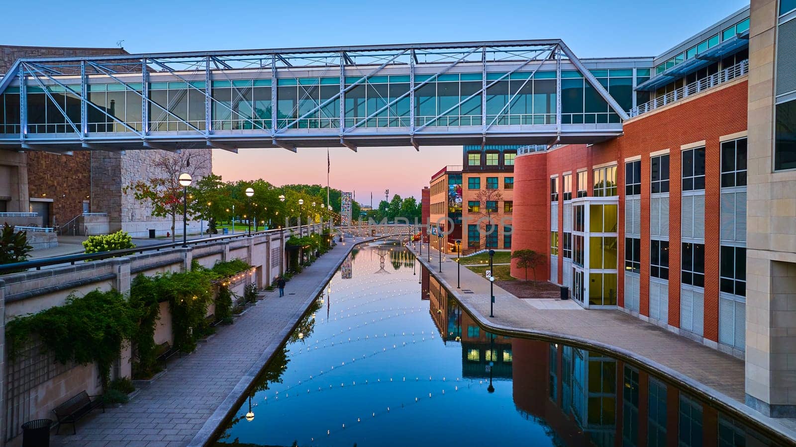 Twilight Urban Landscape with Modern Pedestrian Bridge over Reflective Canal in Indianapolis, 2023