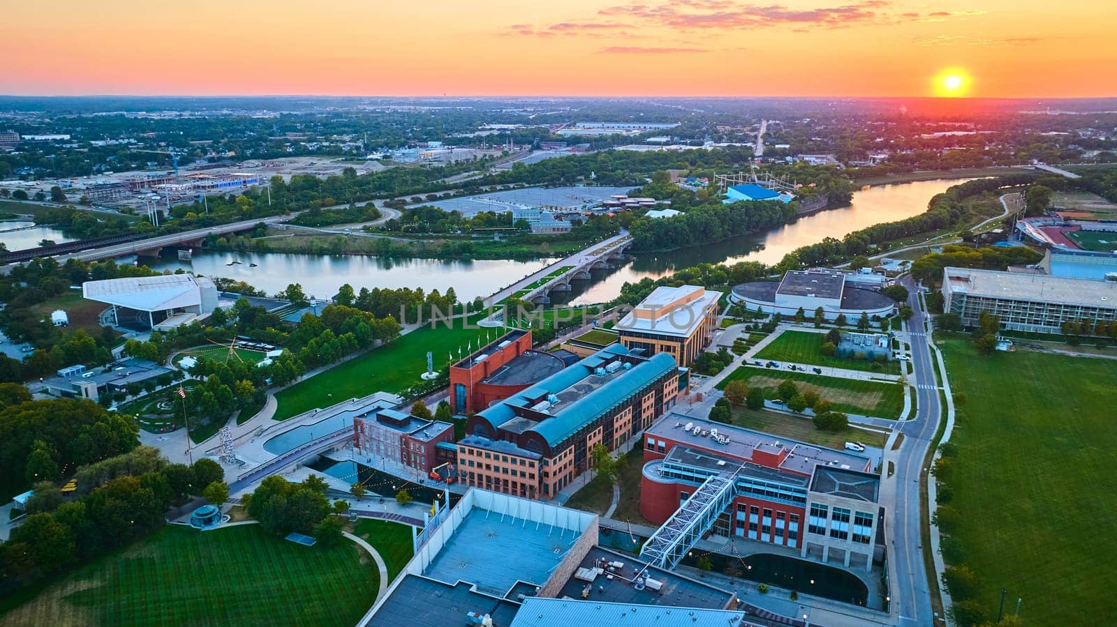 Sweeping Sunrise over Indianapolis, Capturing Urban Landscape with Drone, Showcasing City's Blend of Modern Architecture and Nature