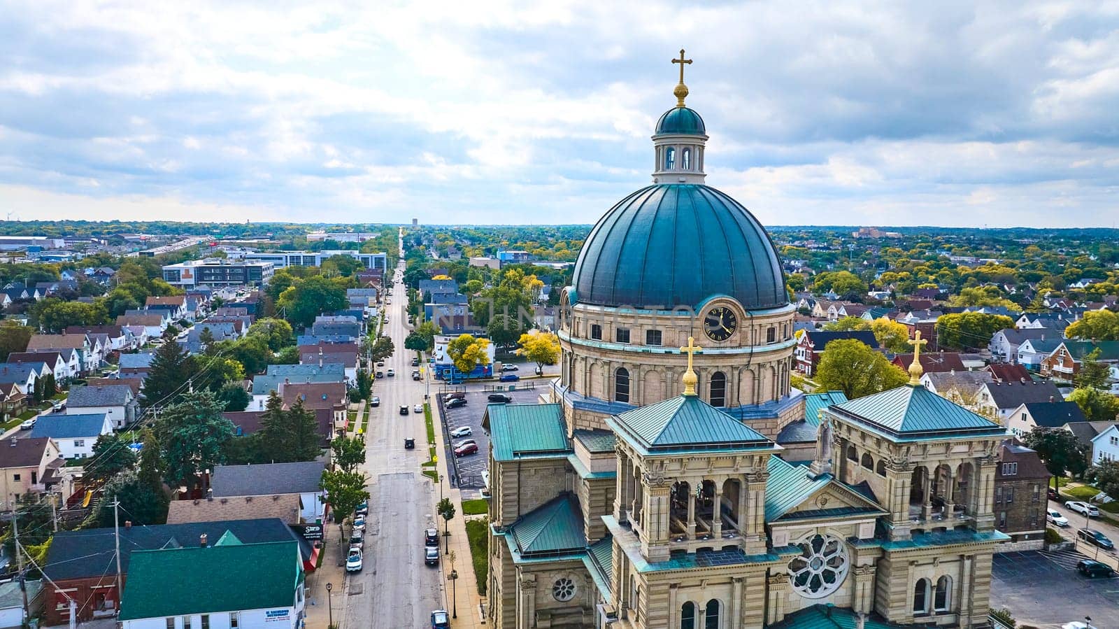 Aerial view of the Basilica of St Josaphat in Milwaukee, depicting vibrant blend of urban life and classical architecture.