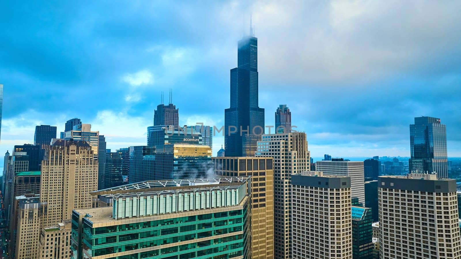 Image of Willis Tower soaring above Chicago downtown skyscraper buildings with gorgeous fog in tourism aerial