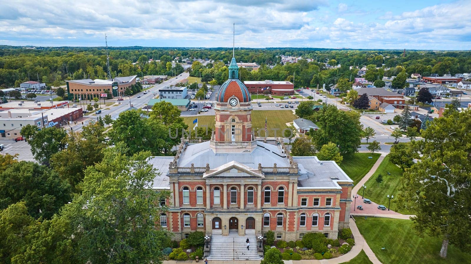 Aerial View of Historic Elkhart County Courthouse, Indiana Surrounded by Lush Greenery and Small Town Scenery