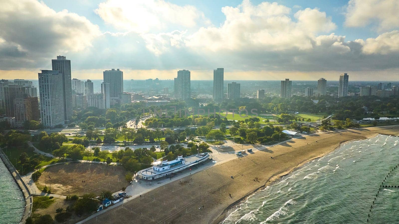 Image of Sandy beach along Chicago coast with Lake Michigan aerial, skyscraper buildings in summer with park