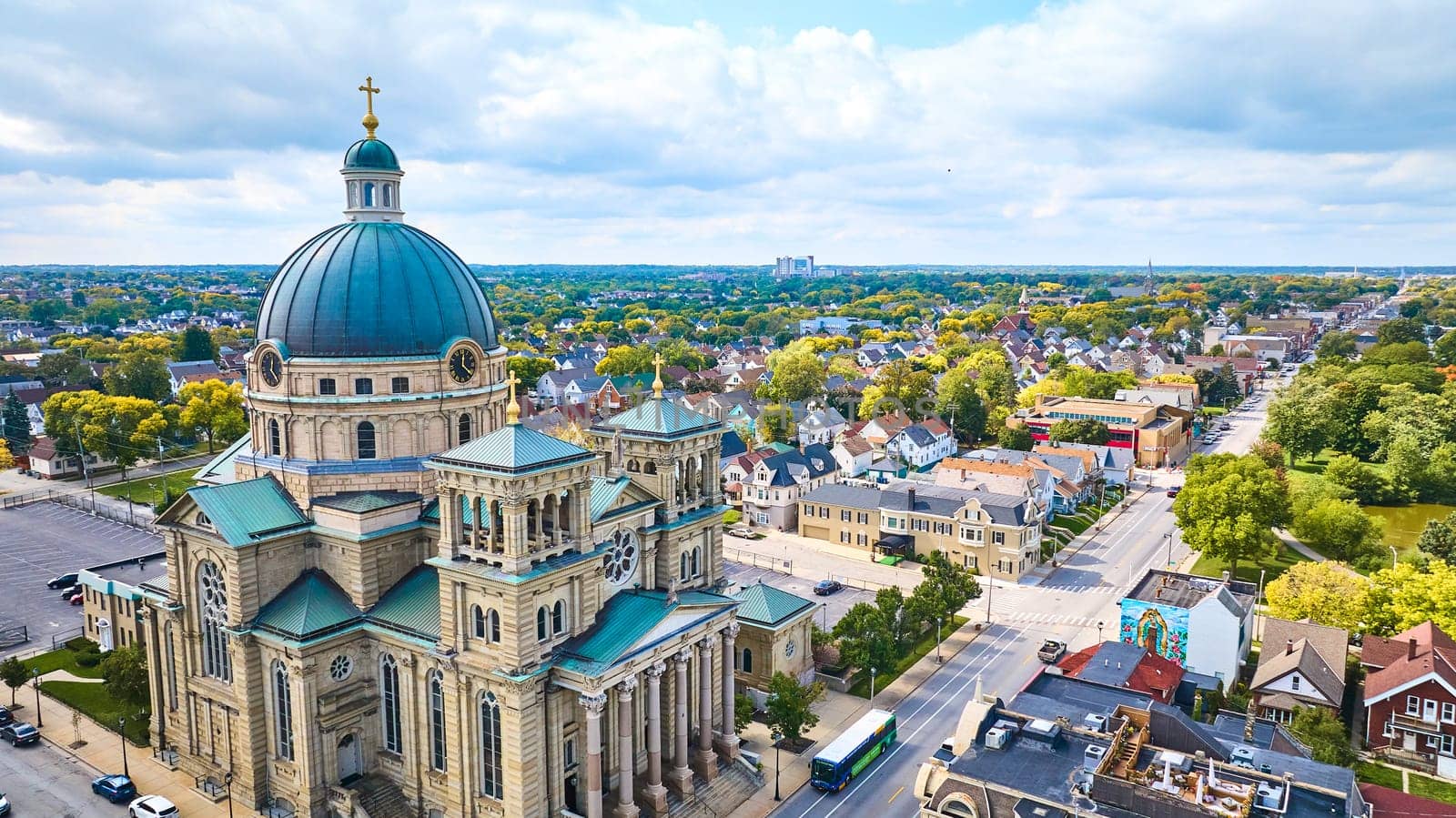 Aerial view of historical Basilica of St Josaphat in Milwaukee, Wisconsin, showcasing its grand architecture amidst suburban landscape, shot with DJI Mavic 3 drone.
