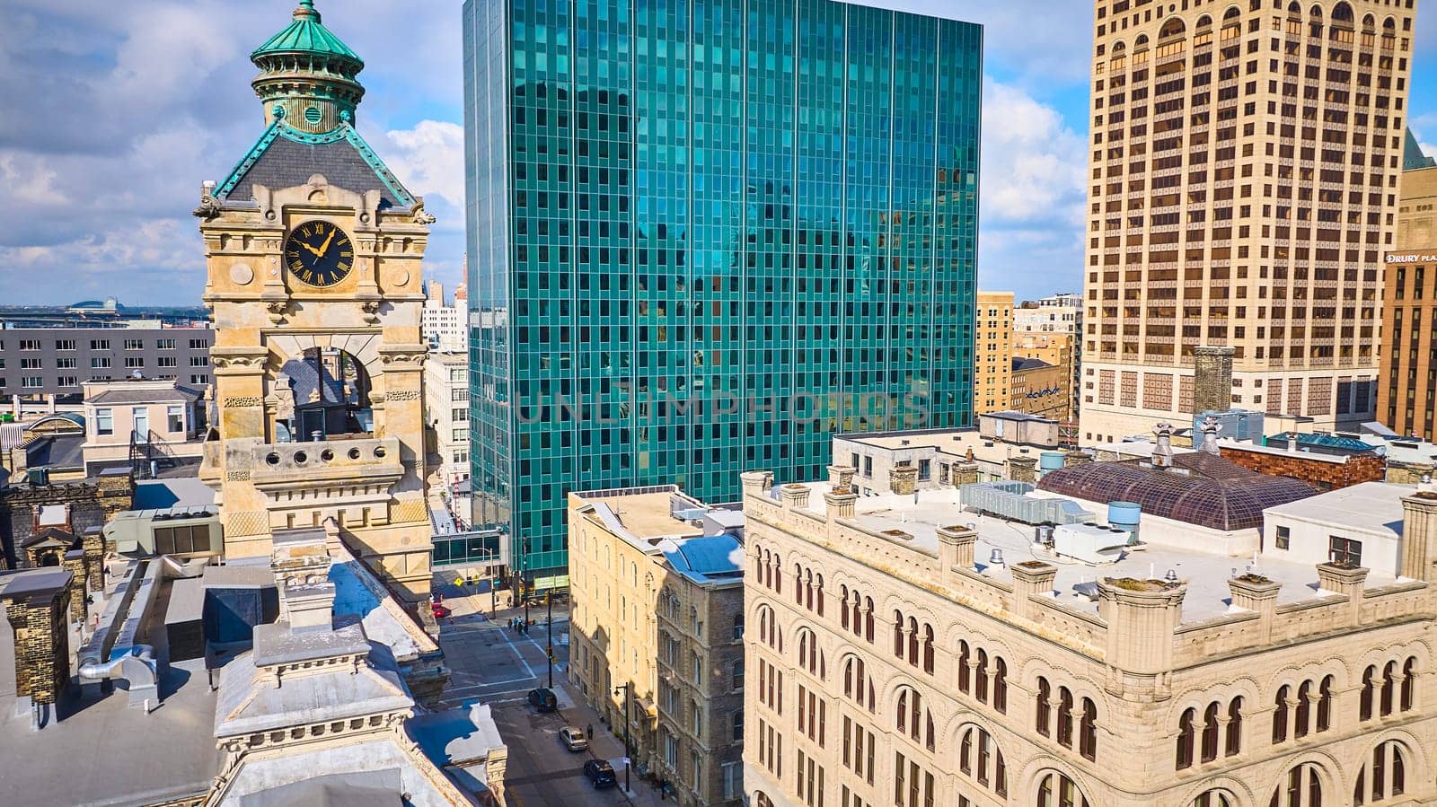 Aerial view of Milwaukee's historic clock tower contrasted against modern skyscraper, showcasing city's architectural diversity.