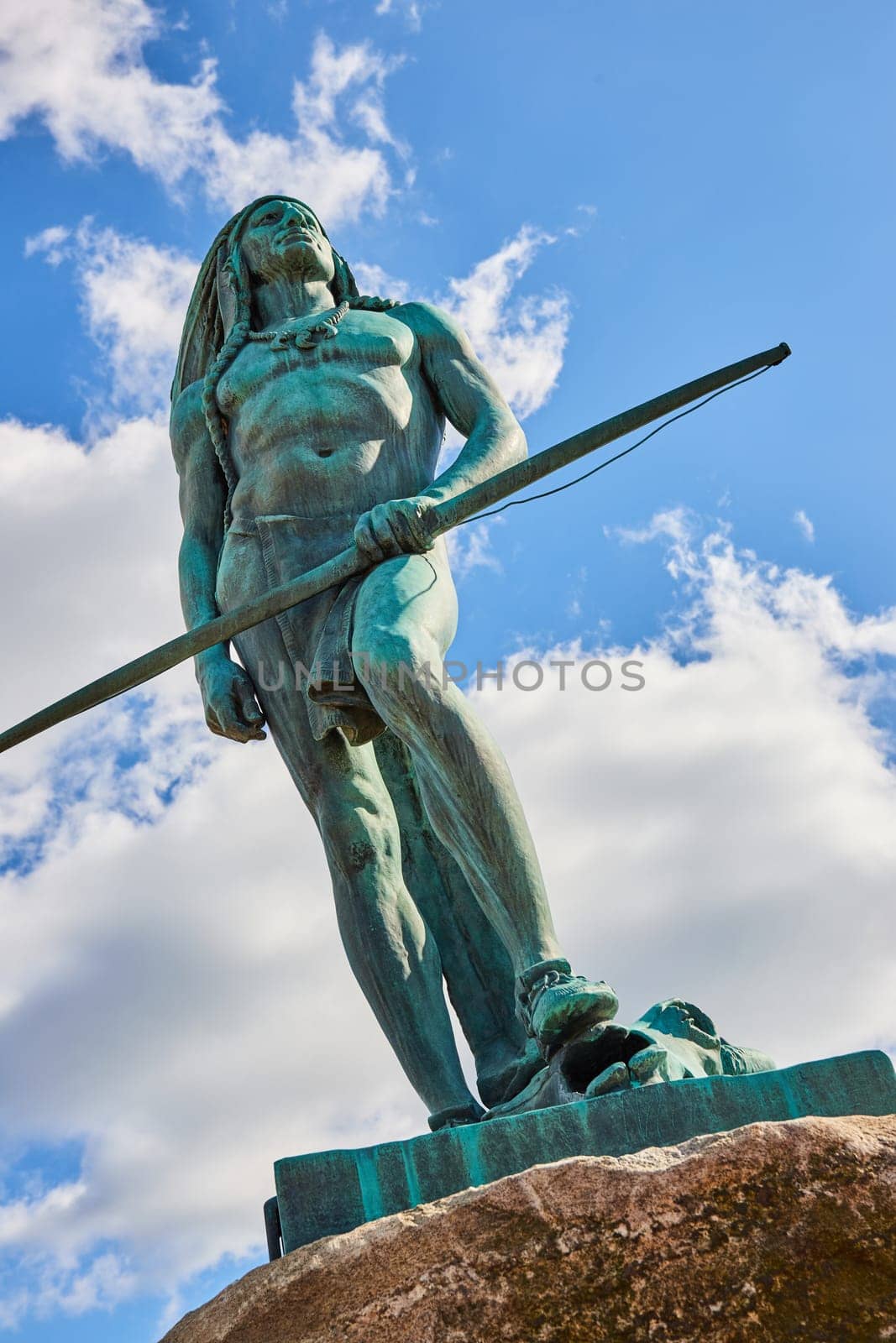 Majestic Bronze Statue in Downtown Muncie, Indiana, Representing Strength and Vigilance against a Vivid Blue Sky