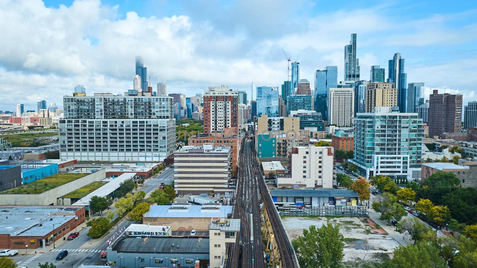 Image of Aerial with railroad tracks leading into skyscraper buildings in downtown Chicago, IL