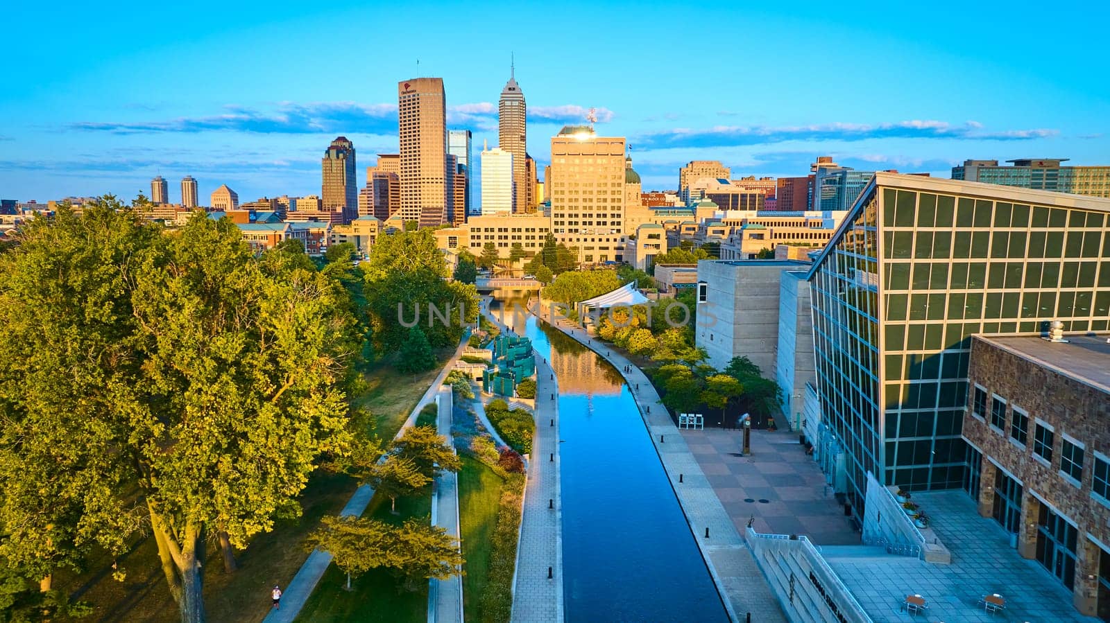 Aerial Golden Hour Cityscape with Urban Canal and Skyscrapers by njproductions