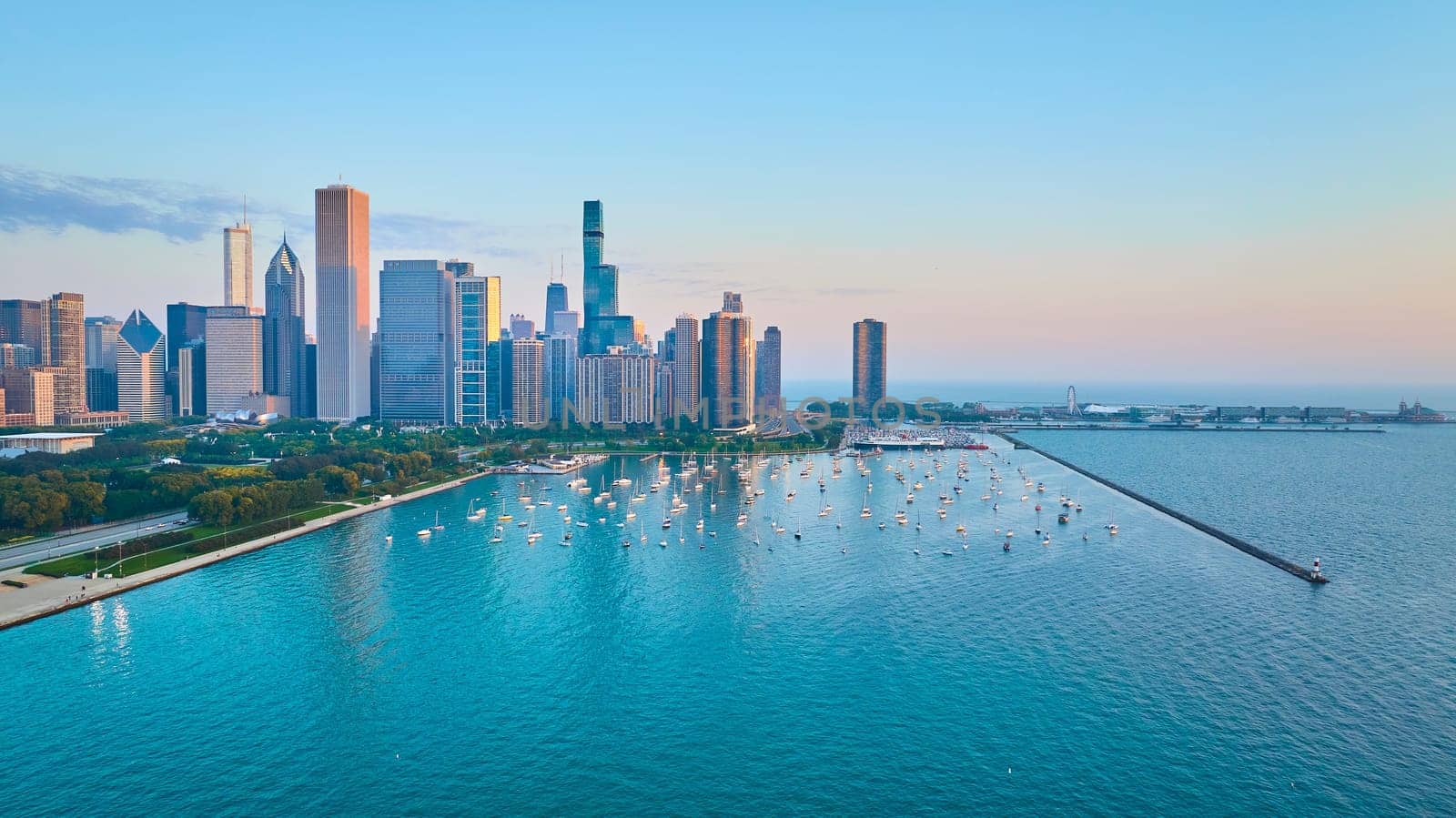 Image of Aerial sail boats in harbor at Chicago city with skyscrapers at sunrise and Lake Michigan water