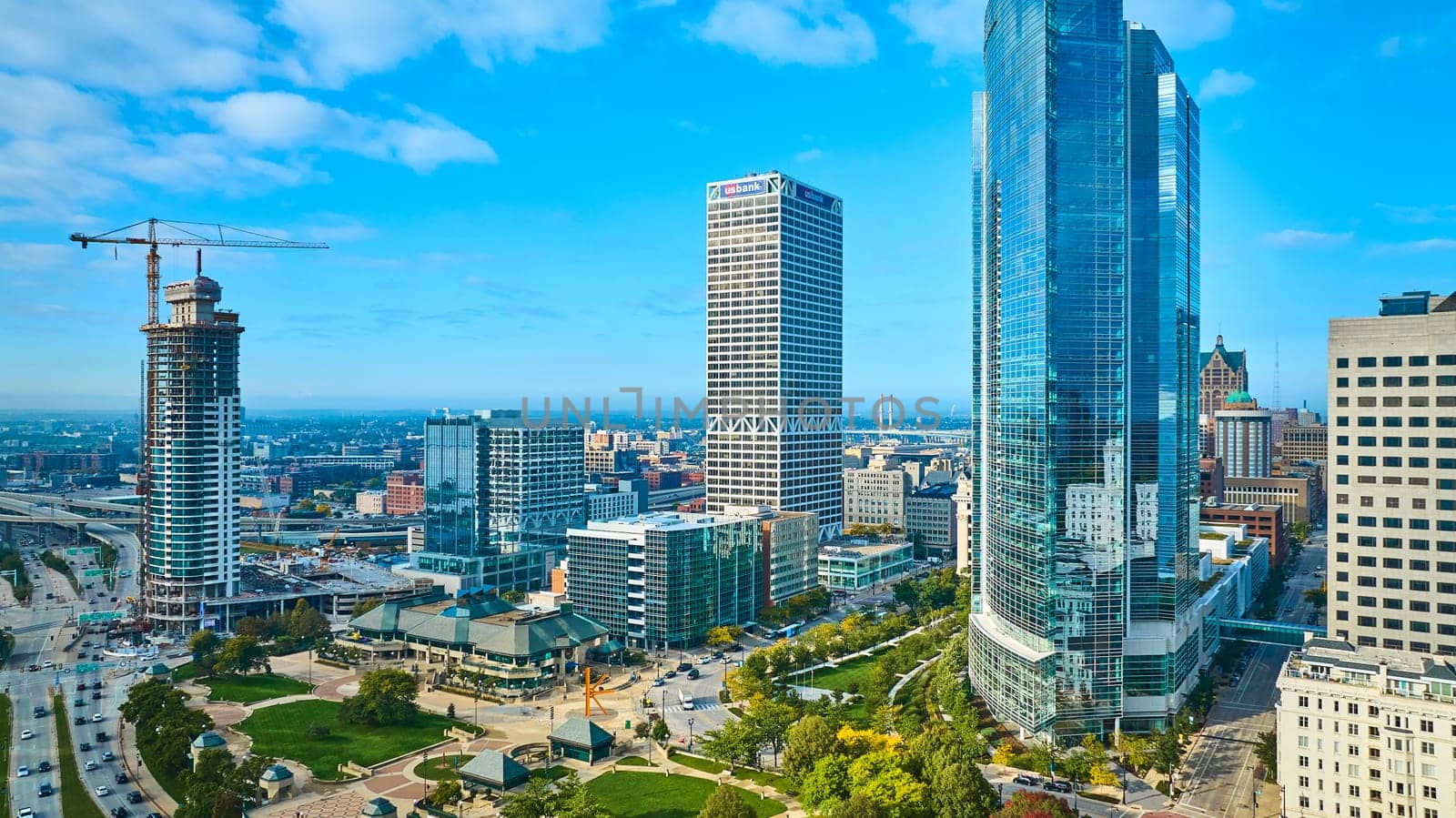 Vibrant 2023 aerial view of Milwaukee, Wisconsin showcasing a mix of modern skyscrapers, ongoing construction, and corporate financial presence, reflecting urban growth and dynamism.