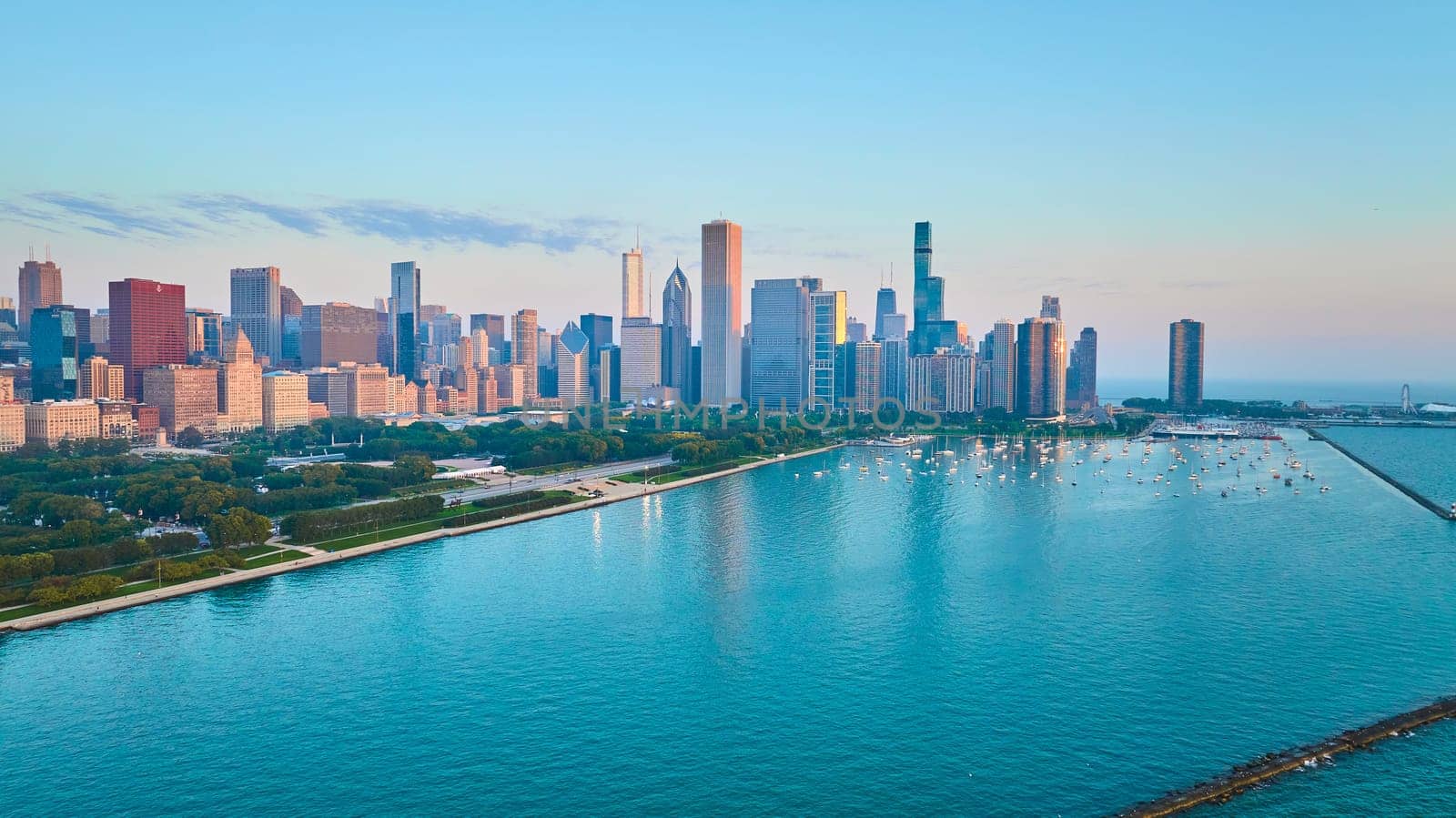 Blue harbor water, Lake Michigan aerial of Chicago coastline with skyscrapers in summer at sunrise by njproductions