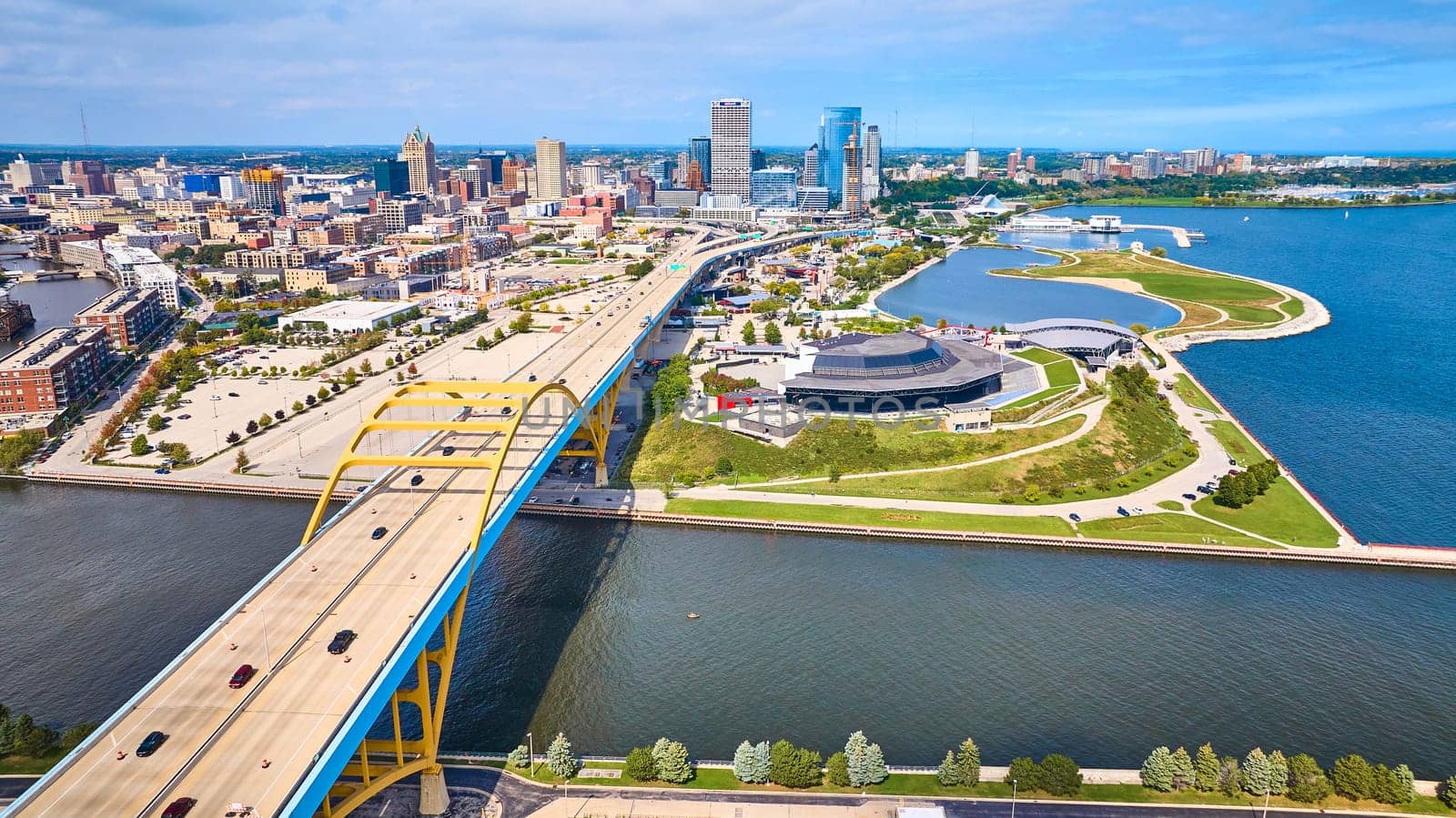 Sunny Day Aerial View of Daniel W. Hoan Memorial Bridge Spanning Lake Michigan, Milwaukee's Vibrant Waterfront Park, and Bustling Downtown Skyline