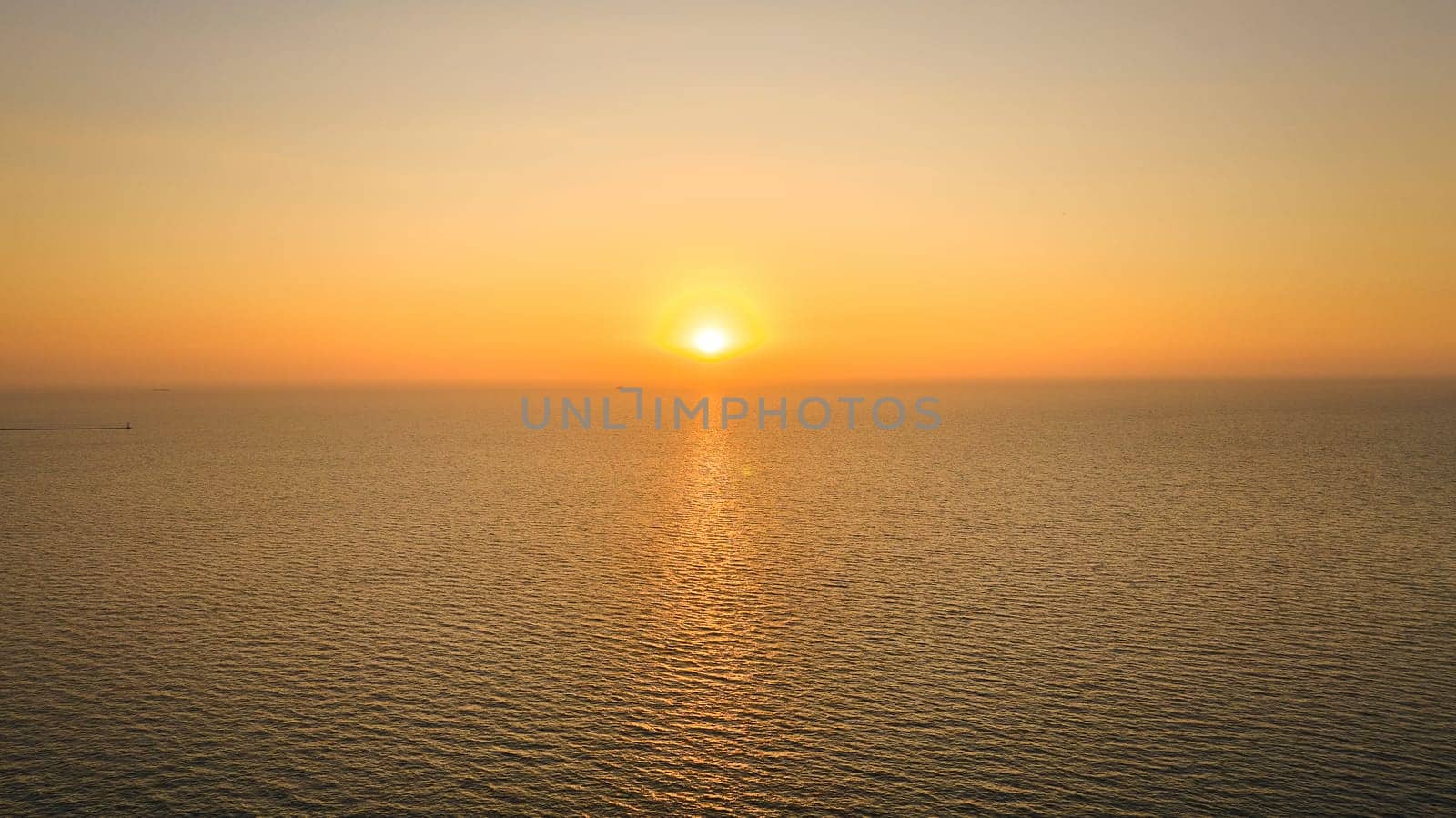 Image of Aerial over water with inspiring sun rising over great Lake Michigan, sunrise at dawn, Chicago, IL
