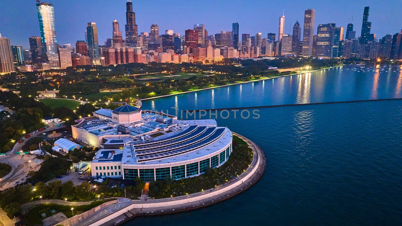 Image of Aerial with aquarium and city lights at night reflection on Lake Michigan water, Chicago IL