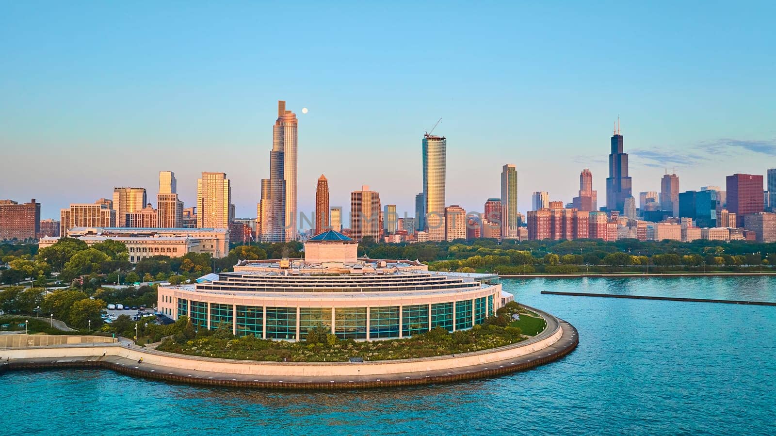 Image of Shedd Aquarium aerial of coast at sunrise with Lake Michigan in summer Chicago skyscrapers, IL