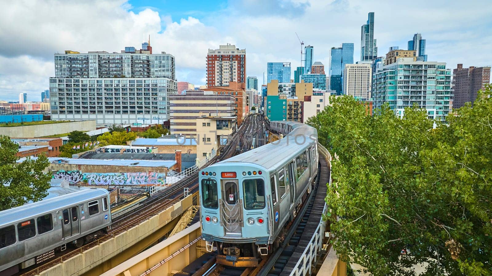 Image of Passenger trains tourism travel in big city with downtown skyscrapers in summer, Chicago aerial