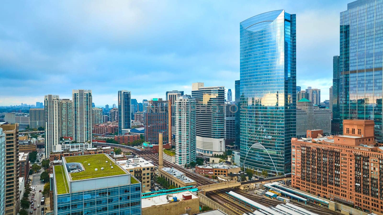 Downtown skyscraper buildings in Chicago aerial with green, eco friendly rooftop in summer by njproductions