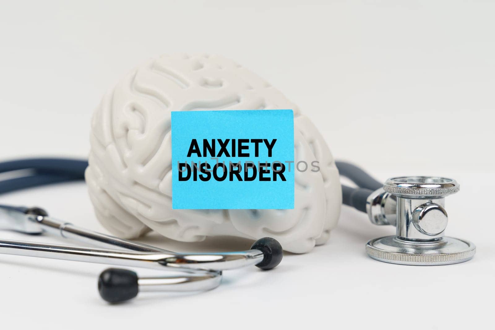 On a white surface next to the stethoscope lies a brain on which a sticker with the inscription - Anxiety disorder by Sd28DimoN_1976