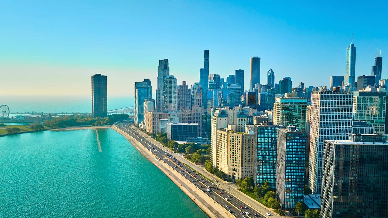 Image of Chicago, IL aerial city skyscraper buildings with clear blue summer sky, tourism, beautiful lake