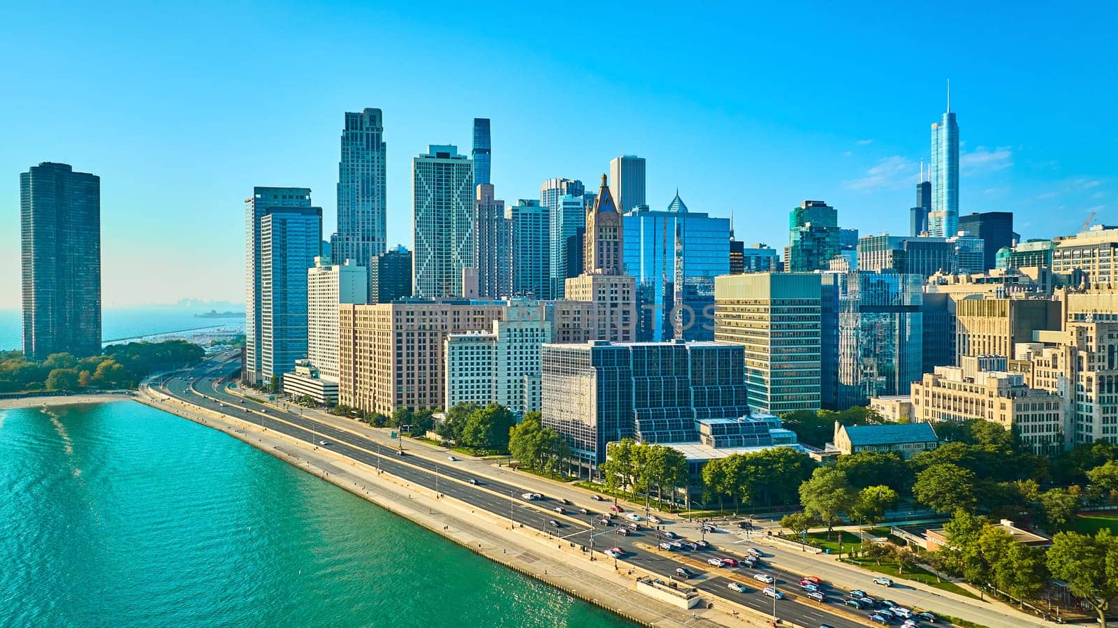 Image of Skyscrapers on Chicago coast with road tourism beside Lake Michigan on gorgeous summer day