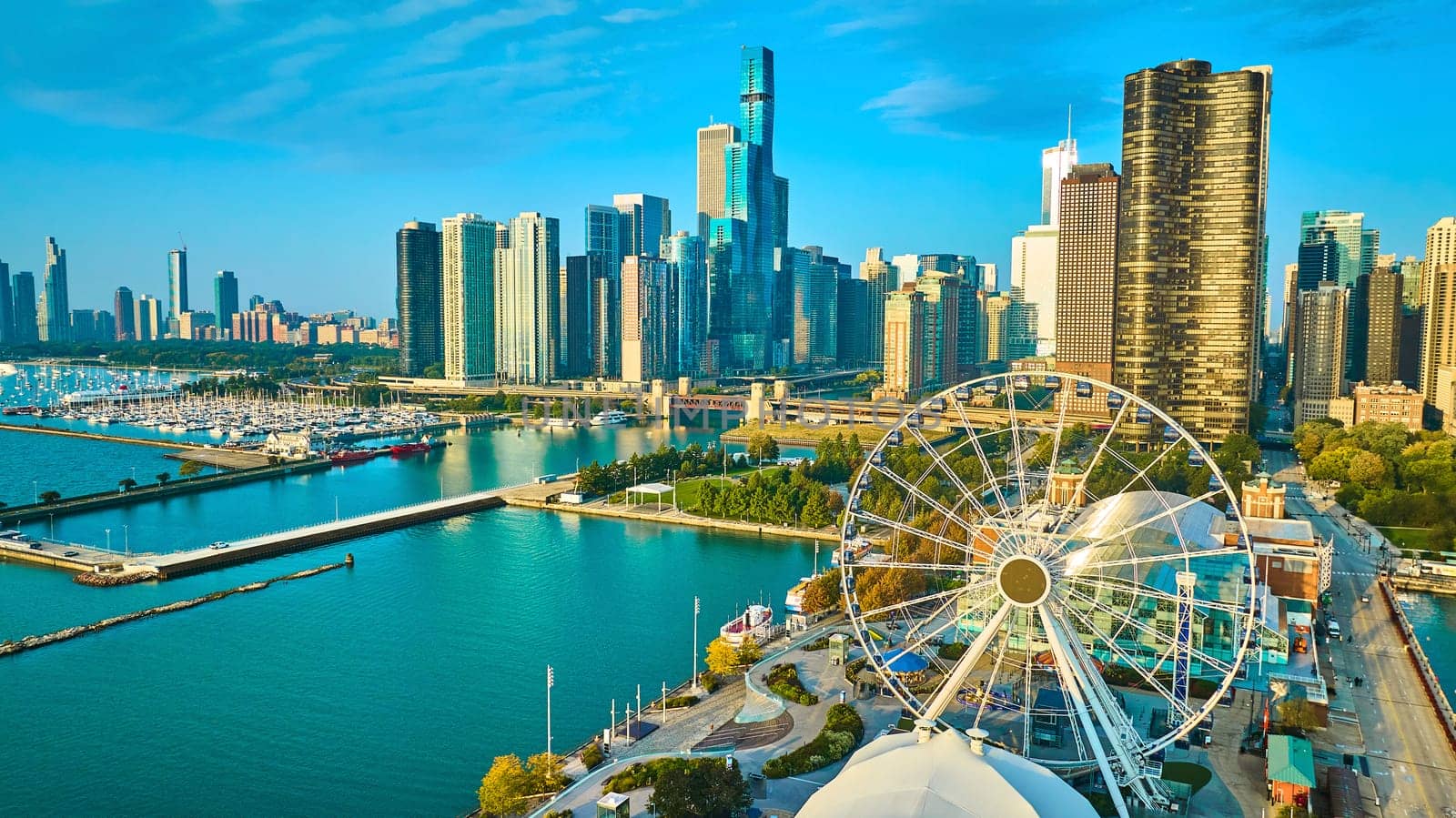 Image of Tourism coast aerial Navy Pier Centennial Wheel sunrise with skyscrapers in Chicago, Lake Michigan