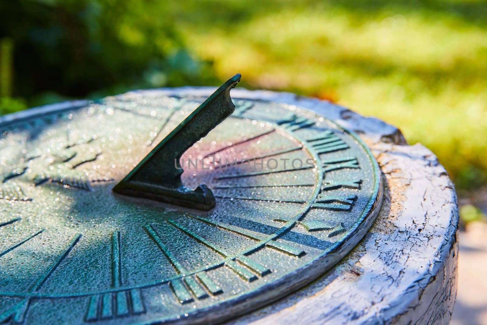 Vintage Sundial in Garden with Morning Dew, Close-Up Perspective by njproductions