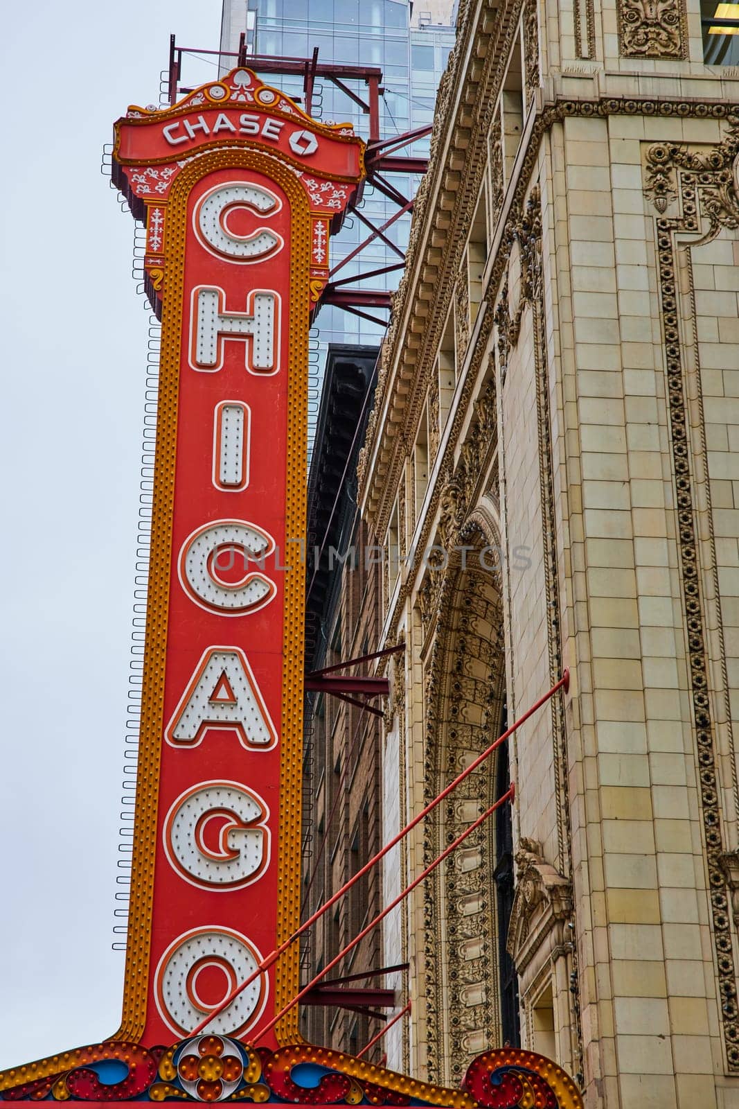 Image of Large orange sign with Chicago in white lettering on white building