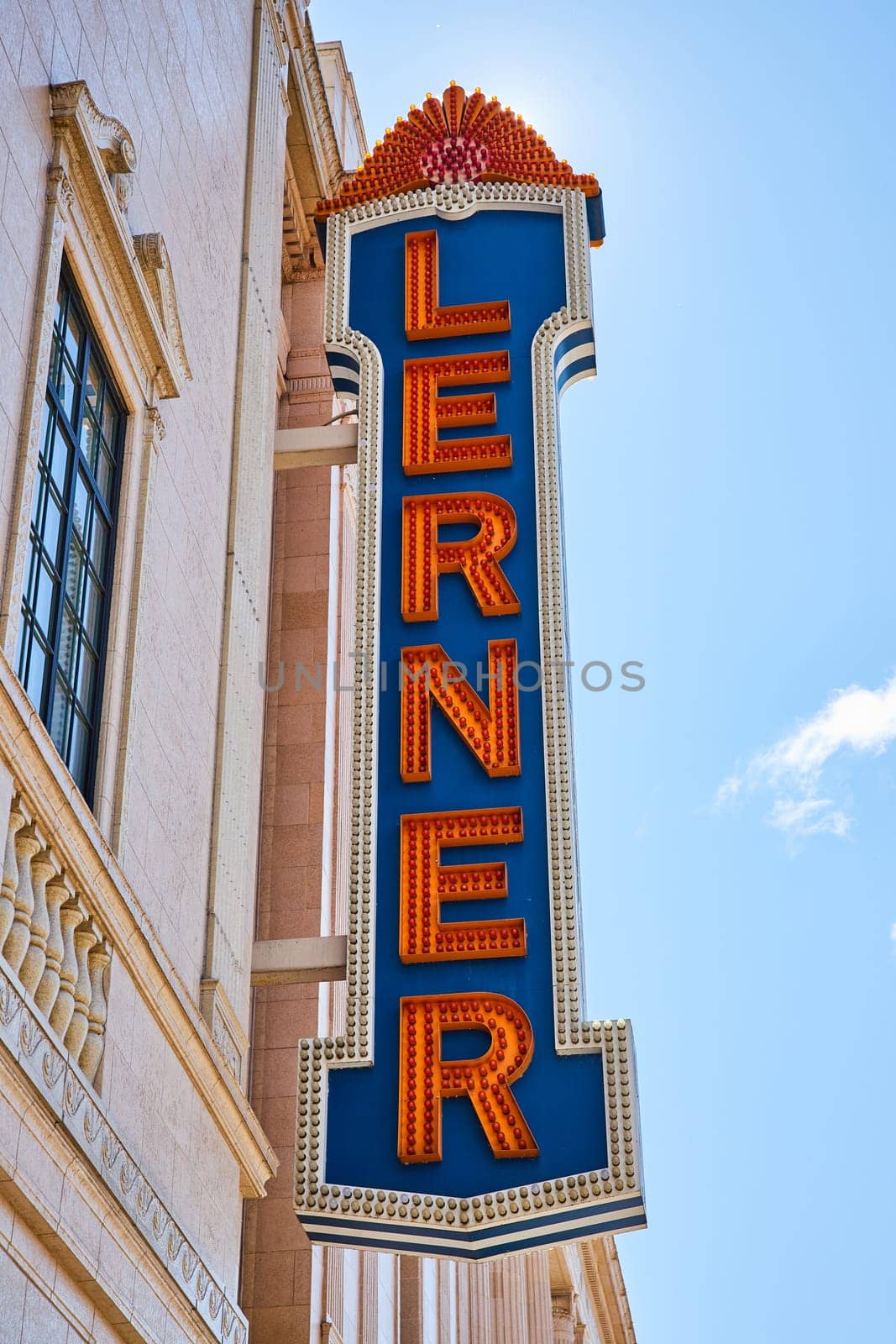Retro marquee sign on historic Lerner theater in downtown Elkhart, Indiana, against a clear blue sky