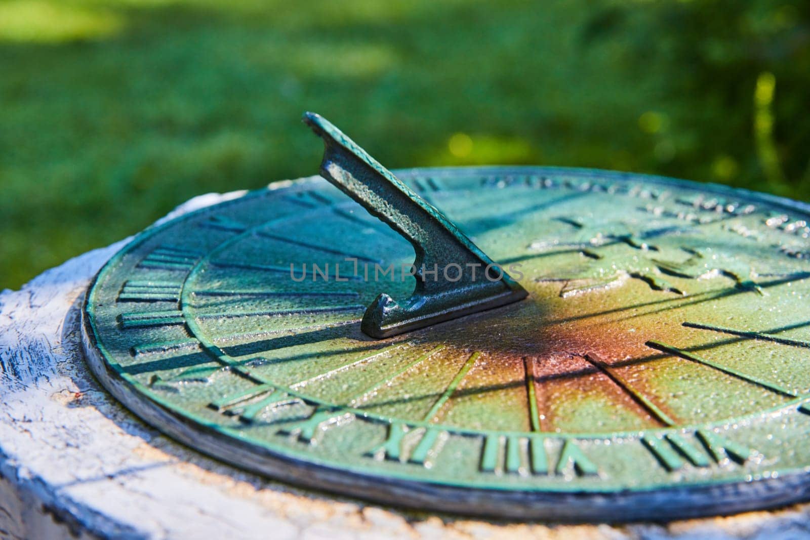 Verdigris Sundial in Garden Light, Close-Up View by njproductions