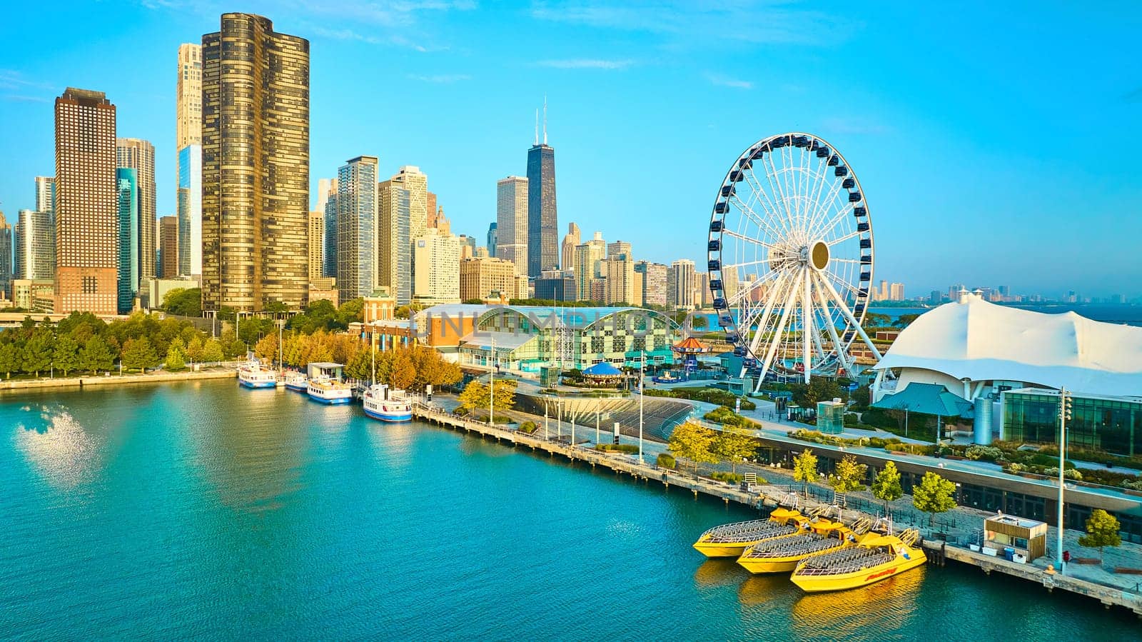 Image of Aerial Centennial Wheel on Navy Pier with Chicago, IL skyscrapers in summer at dawn