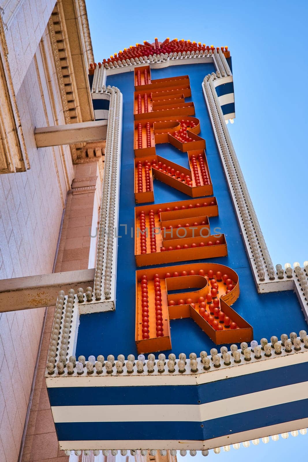 Retro Theater Marquee Sign with Bulbs, Blue Sky Upward View by njproductions