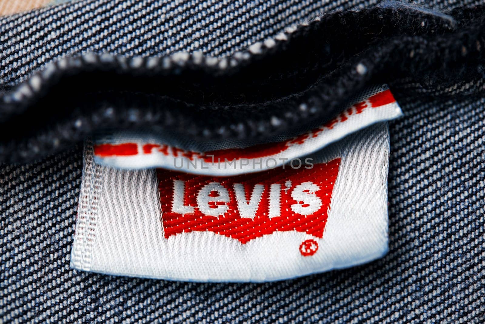 Close up of the of the label of new LEVI'S 501 Jeans on the inside. Logo and stamp LEVI'S on the underside of the textile. Classic jeans model Levi Strauss. 31.12.2021, Rostov, Russia by EvgeniyQW