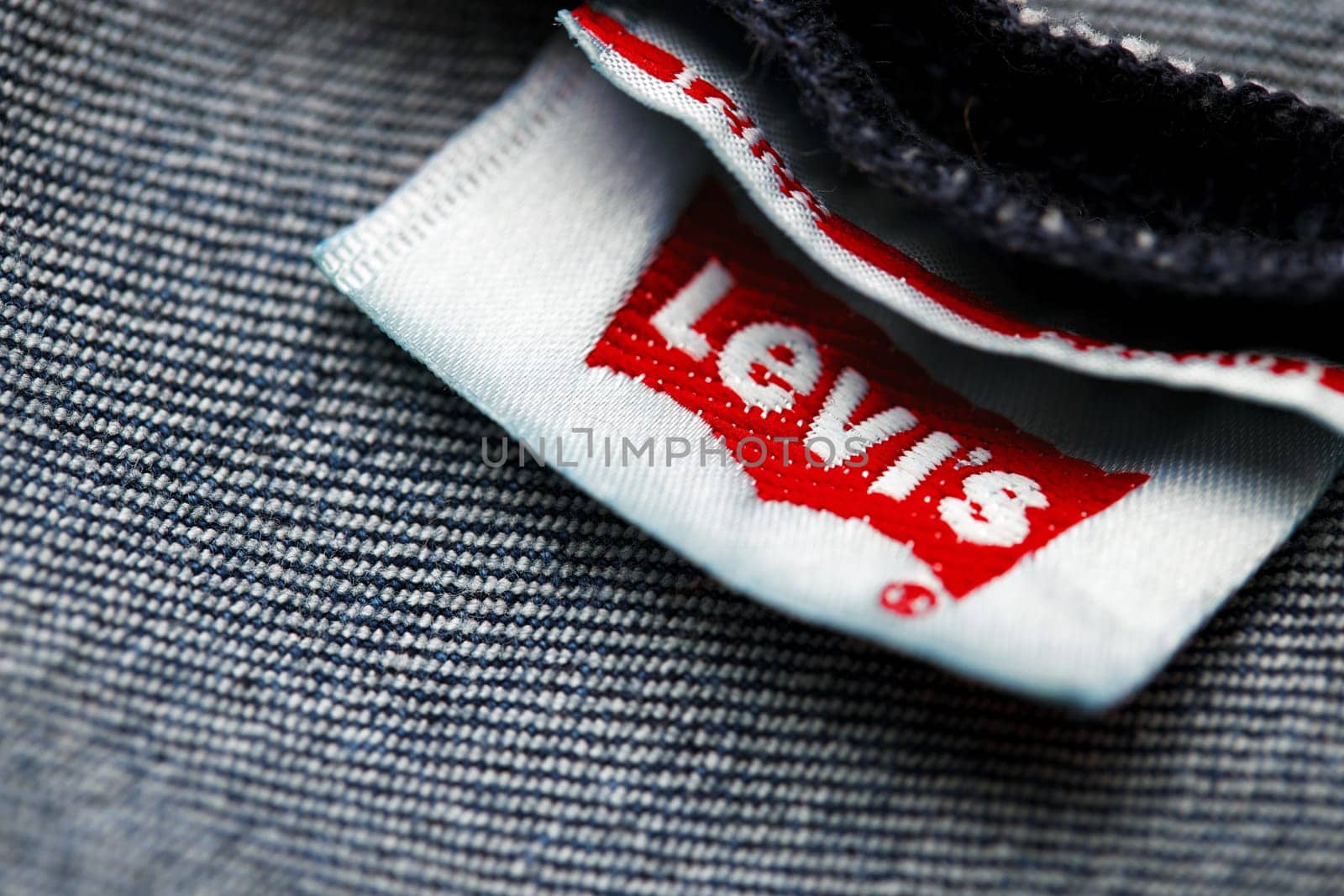 Close up of the of the label of new LEVI'S 501 Jeans on the inside. Logo and stamp LEVI'S on the underside of the textile. Classic jeans model Levi Strauss. 31.12.2021, Rostov, Russia.