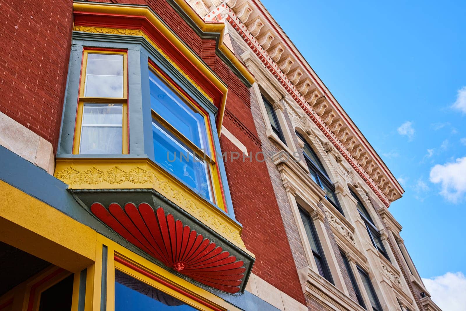 Vibrant contrast of old and new architecture in Downtown Muncie, Indiana under clear blue sky
