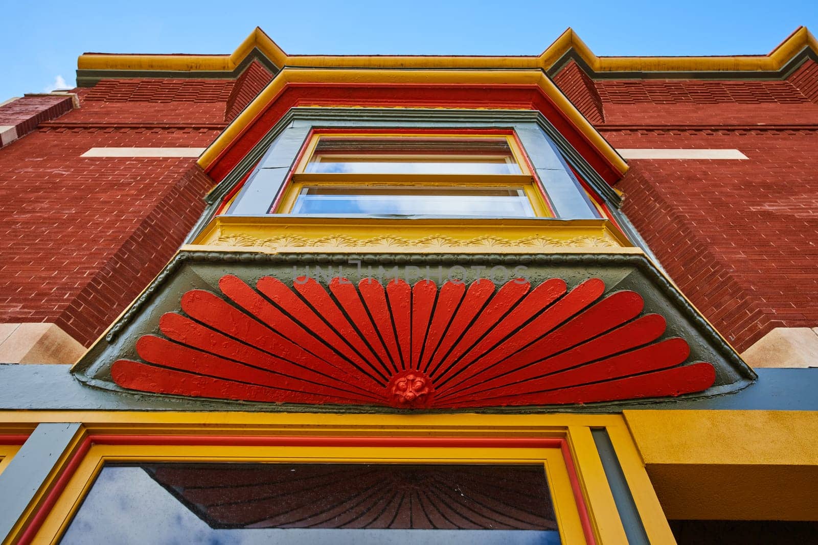 Vibrant Detail of Victorian Architecture in Downtown Muncie, Indiana - Colorful Ornamental Features Under Sunny Sky