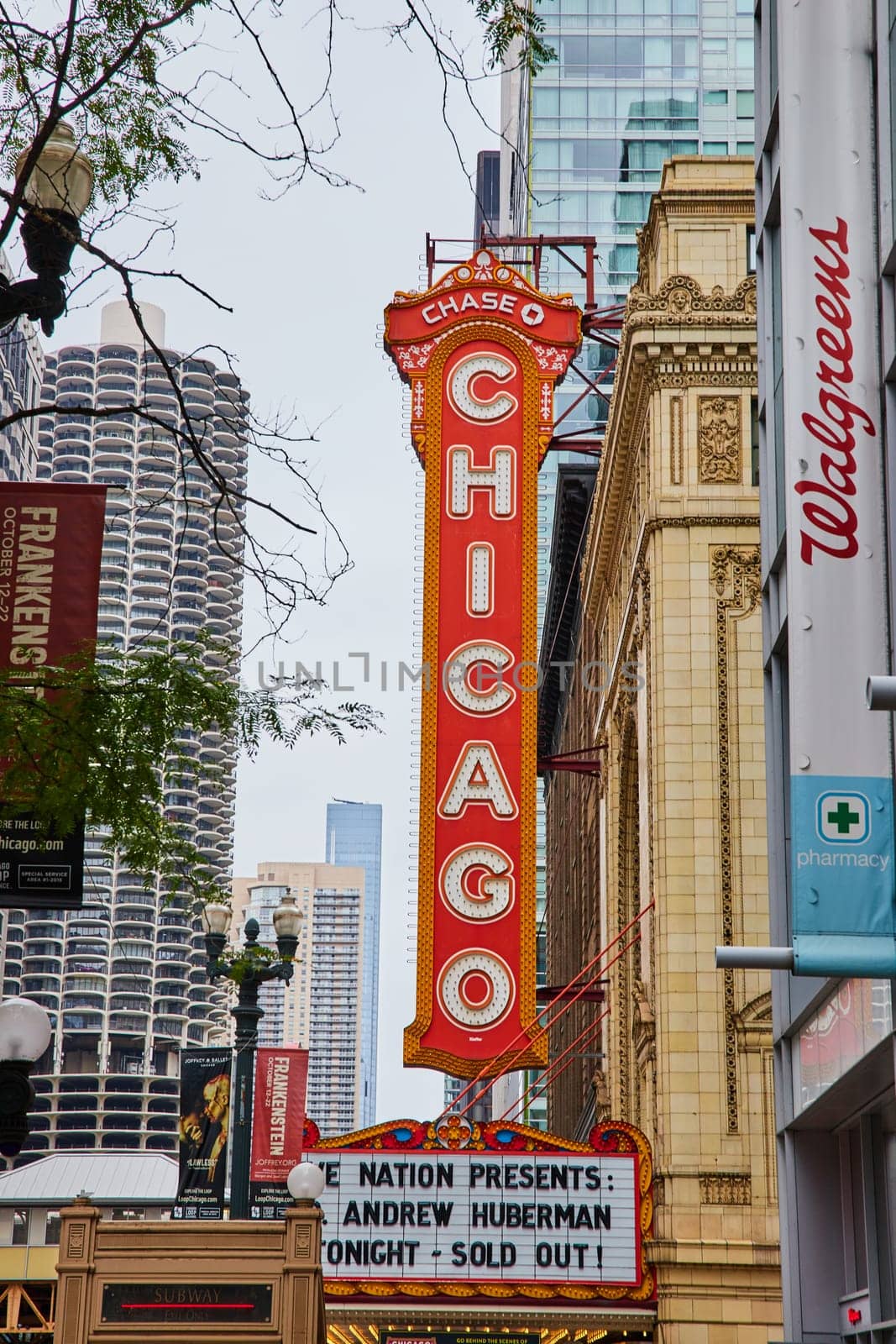 Large orange and yellow Chicago sign with white lettering above a theatre by njproductions