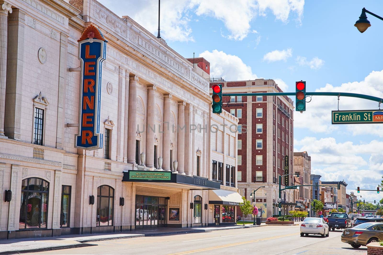 Bustling street view of the iconic Lerner Theatre in downtown Elkhart, Indiana, showcasing a blend of historical architecture and vibrant city life