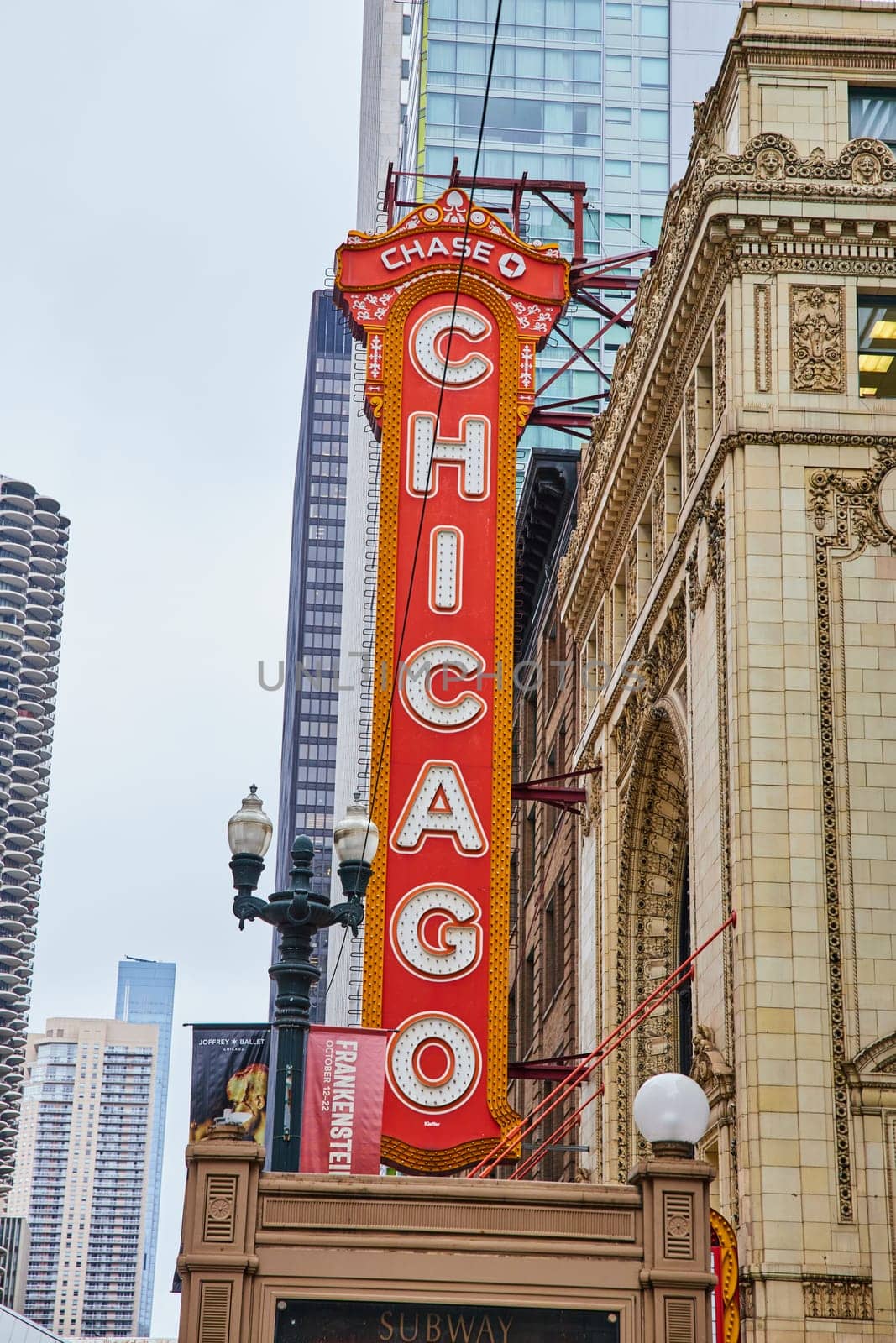 Large orange Chicago sign with white lettering on old historic building in city by njproductions