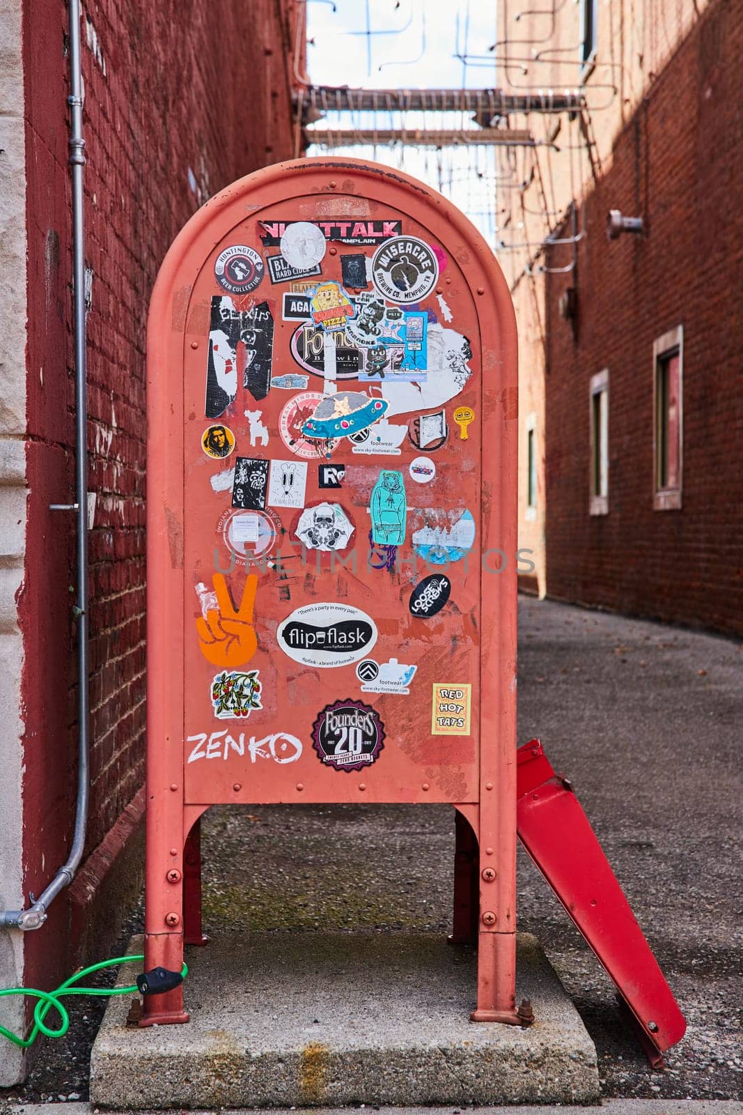 Sticker-Adorned Red Mailbox in Urban Alleyway, Eye-Level View by njproductions