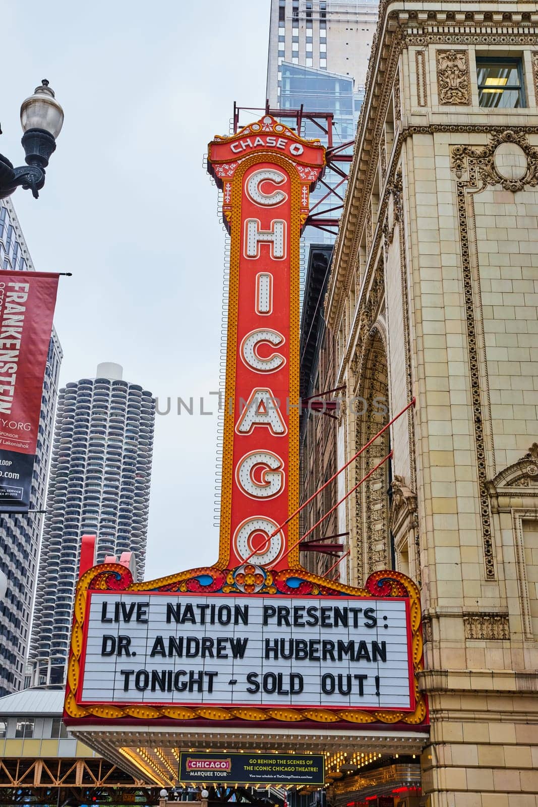 Large orange Chicago sign with white lettering above a theatre sign by njproductions