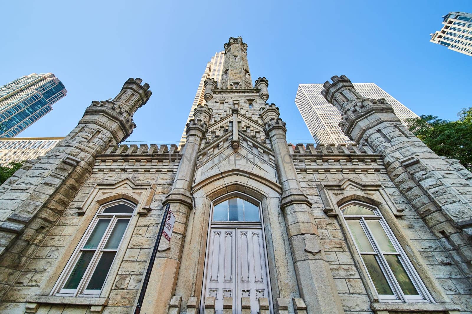 Image of Chicago historic water tower upward castle architecture view under blue sky, skyscrapers, tourism
