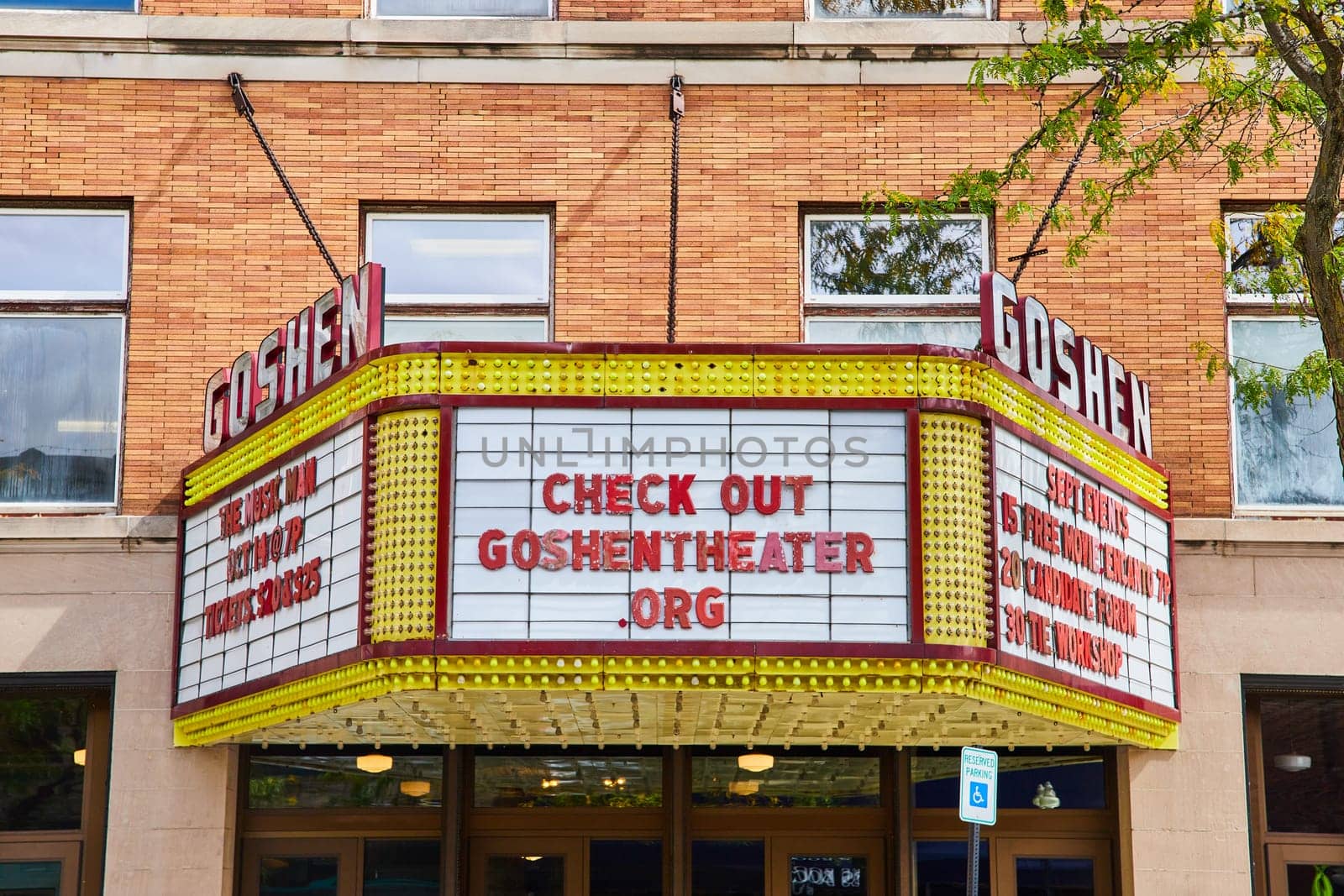 Image of Goshen theater sign and front entrance on bright, sunny summer day, Indiana