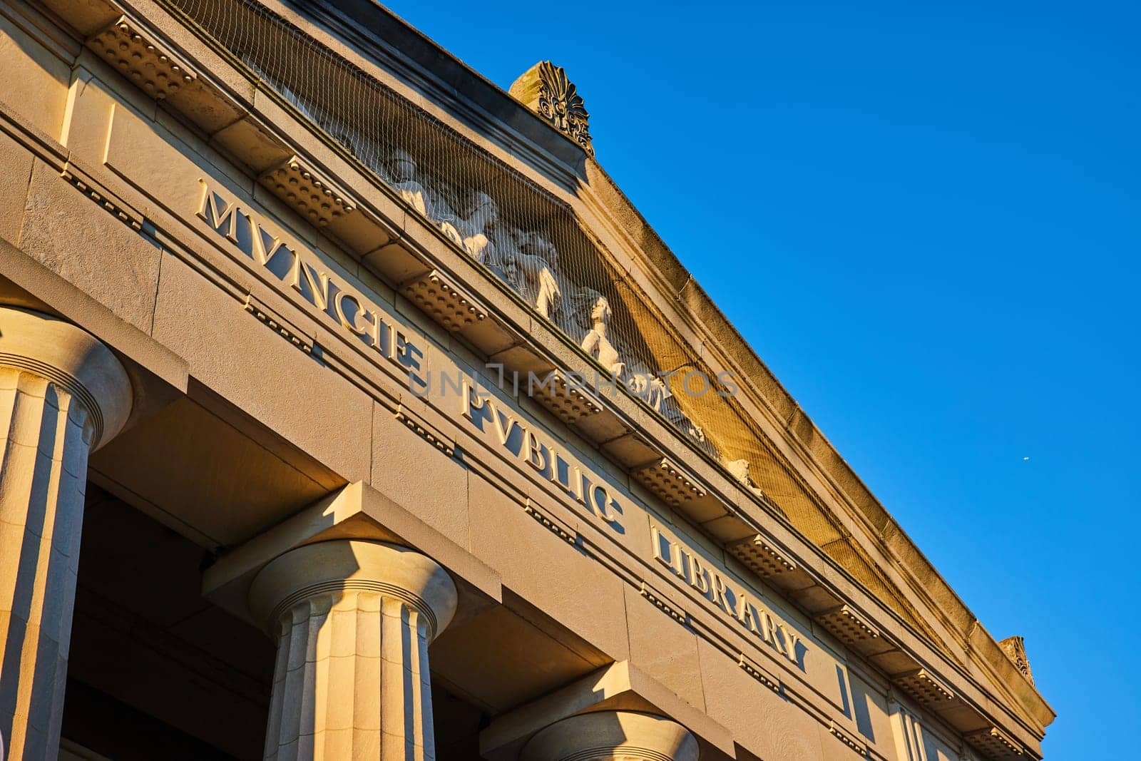 Neoclassical Muncie Public Library Facade at Sunrise with Blue Sky by njproductions