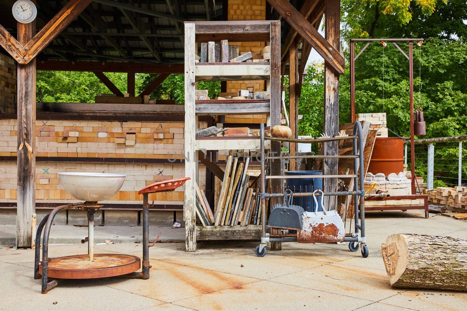 Rustic Artisan Workshop in Daylight - Traditional Pottery Tools, Ceramic Kiln, and Old Basin in an Industrial Outdoor Setting, Art Center, Indianapolis, Indiana 2023