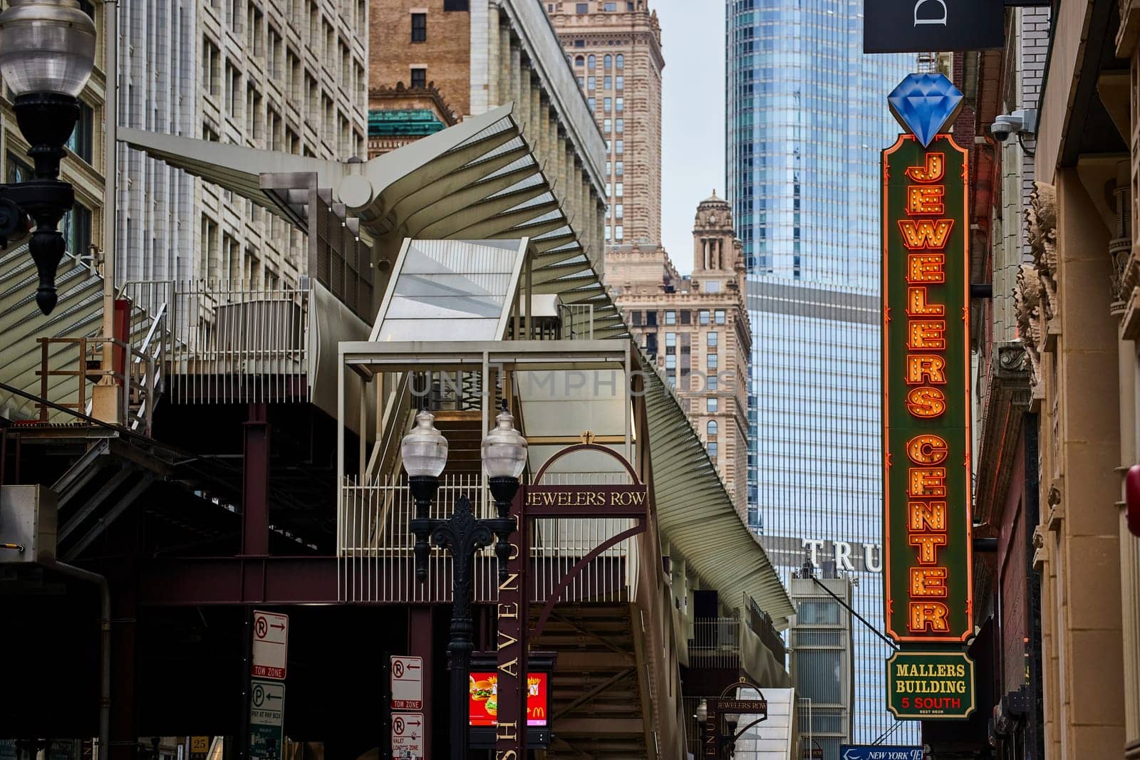 Image of Chicago Jewelers Row transit train station with Trump Tower skyscraper behind yellow lights on sign