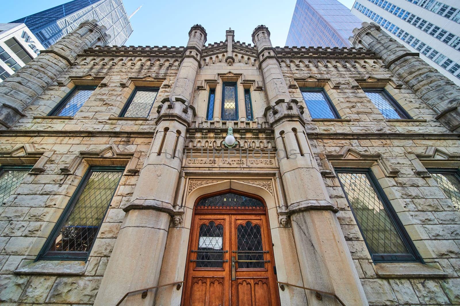 Image of Entrance close Chicago Water Works castle building architecture with wooden doors, upward view